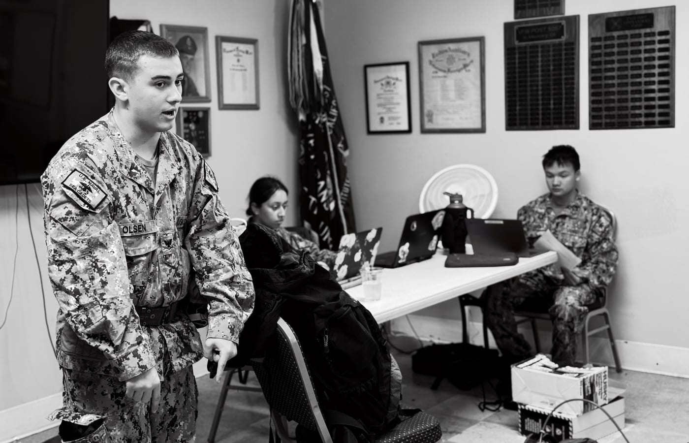 A young cadet leader mentoring a small group of peers